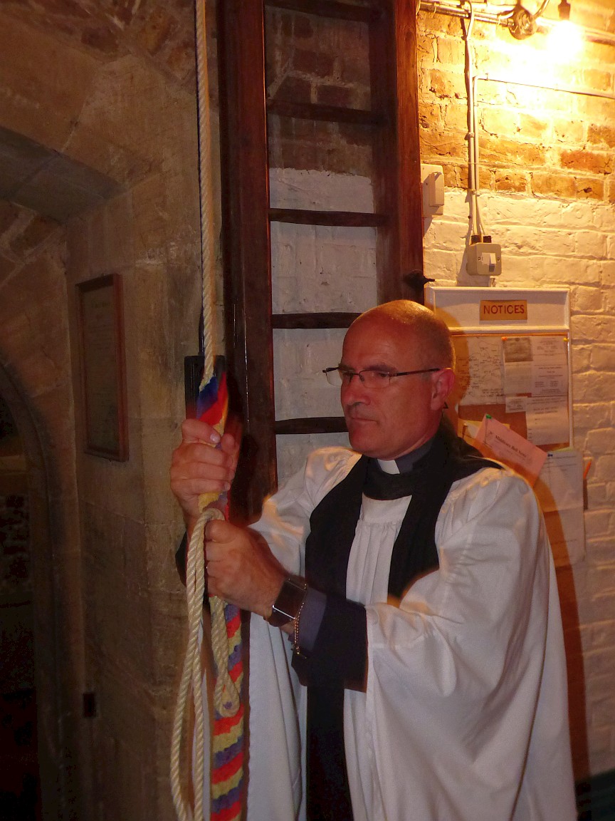 Vicar ringing bell as his symbolic first act